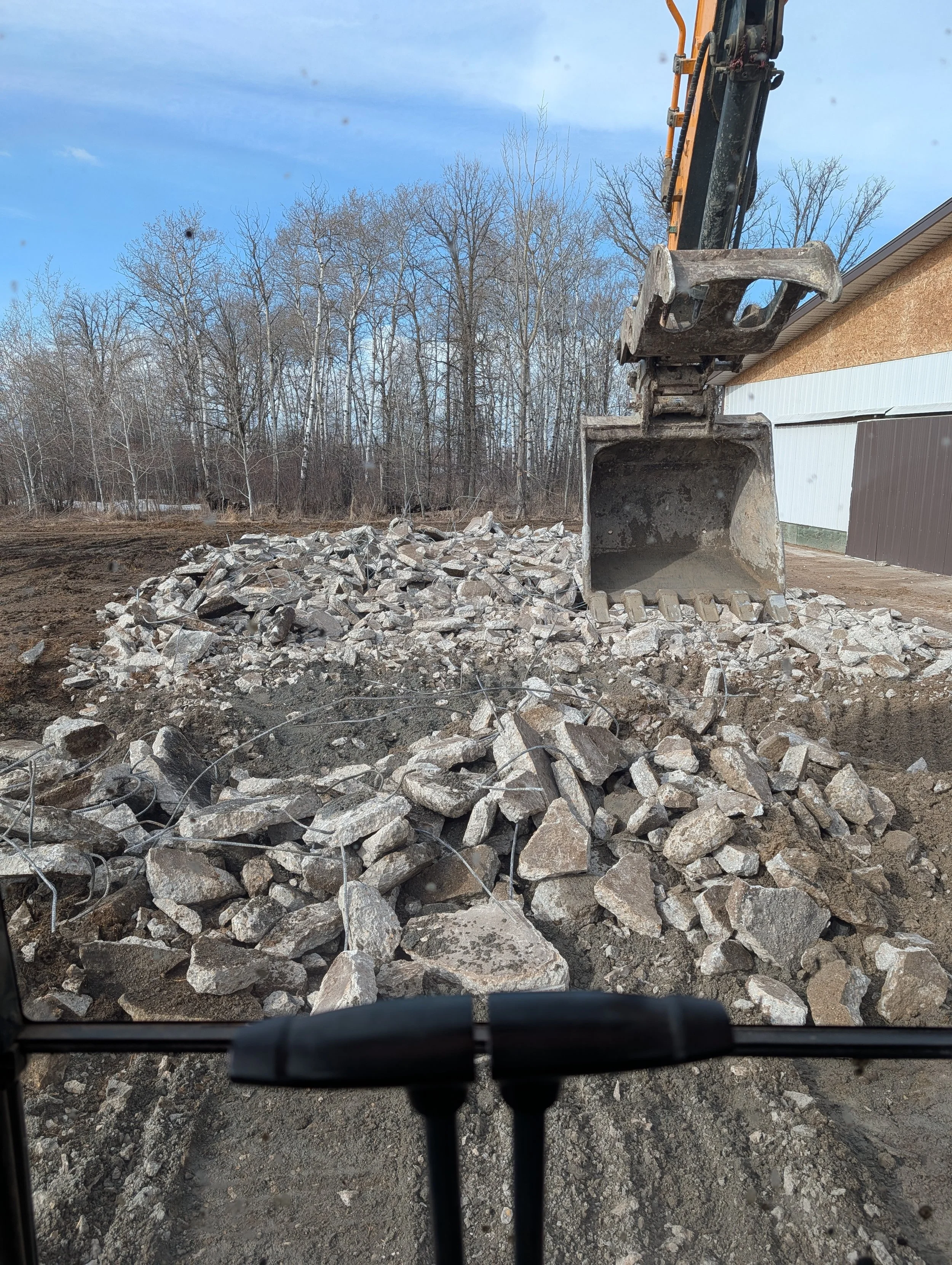 Old pad being broken up and hauled away