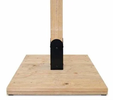 Close-up of a wooden block attached to a vertical wooden post, mounted on a wooden platform.