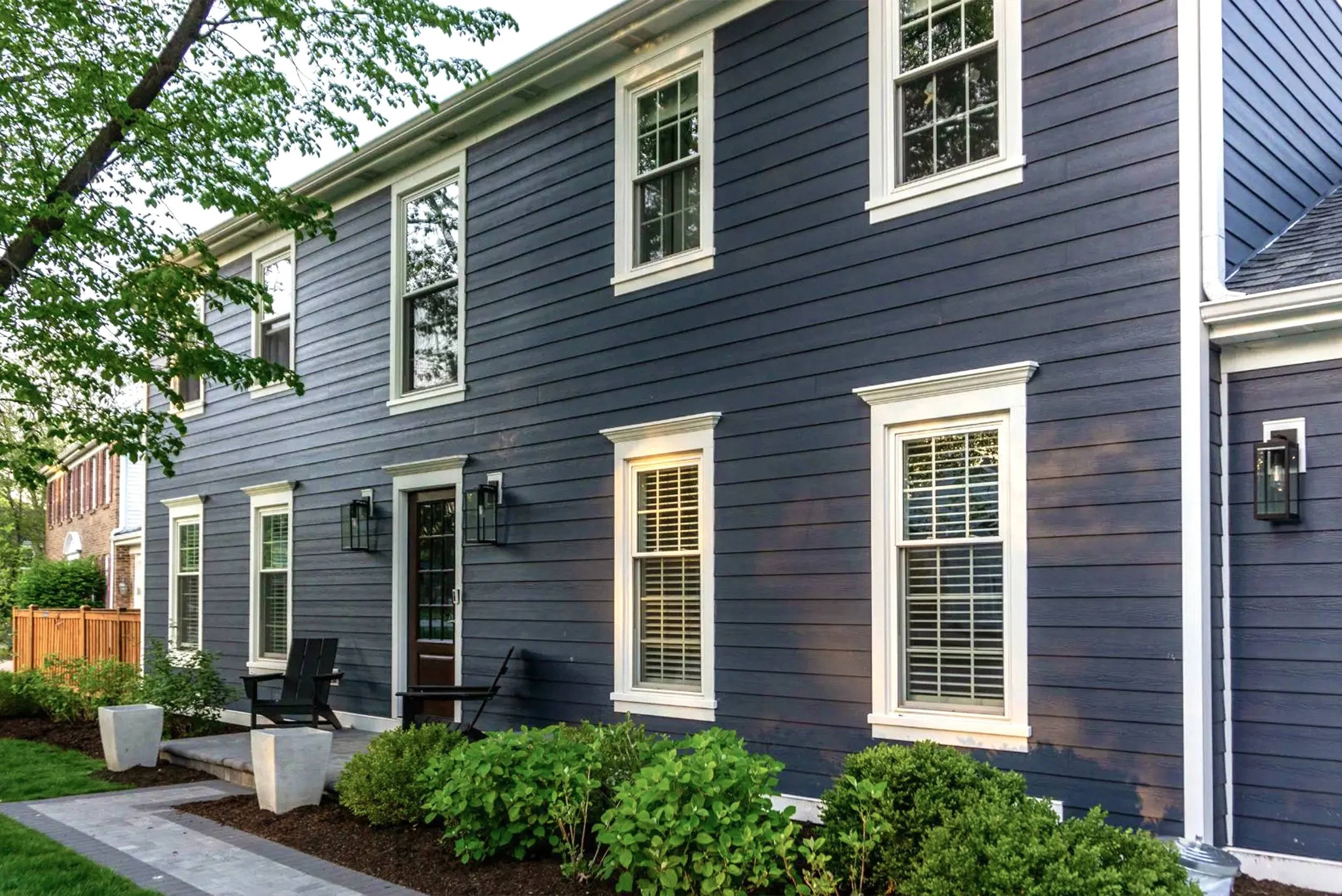 Exterior of a house with blue siding and white trim.