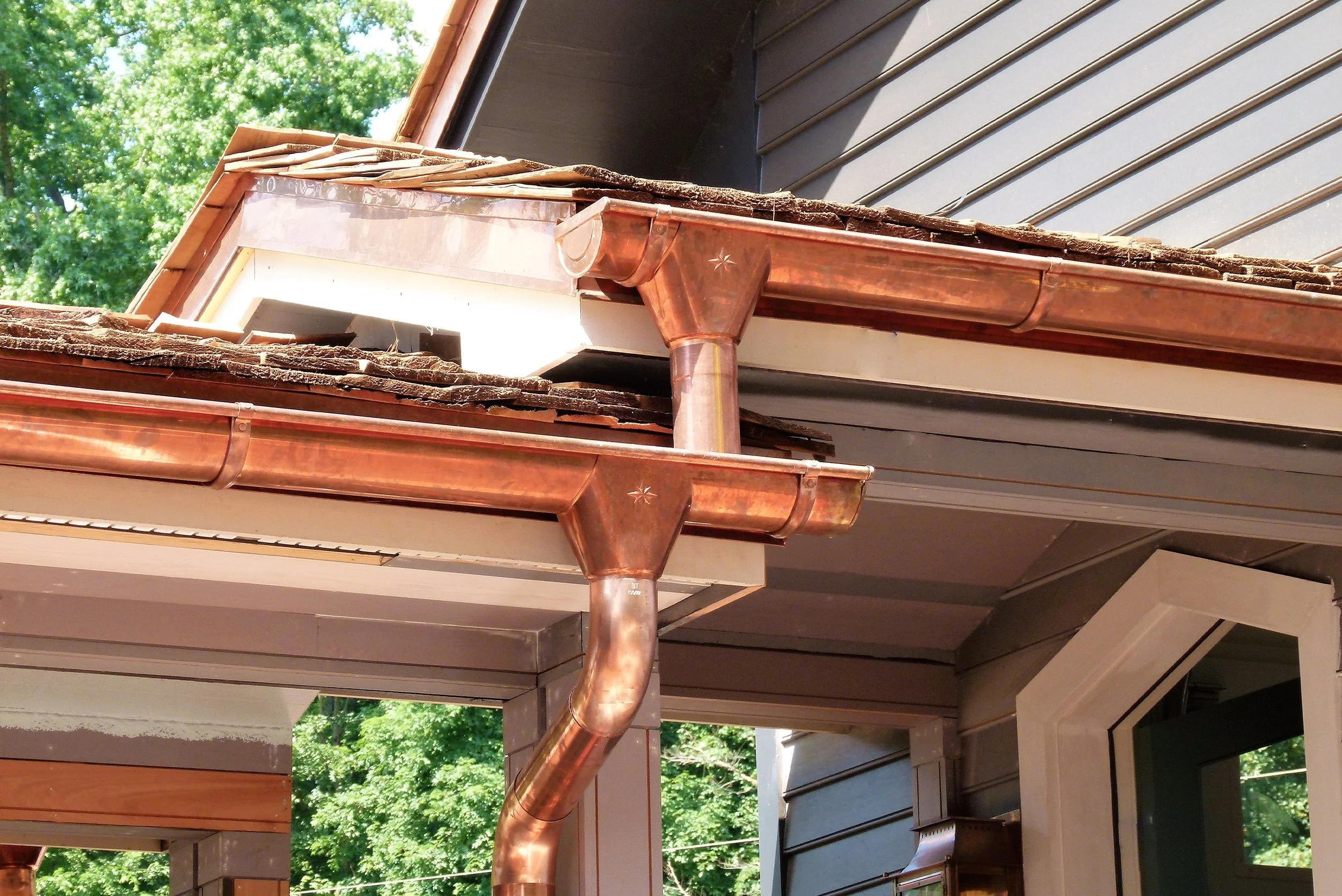 Close-up of a house's roof with copper gutters