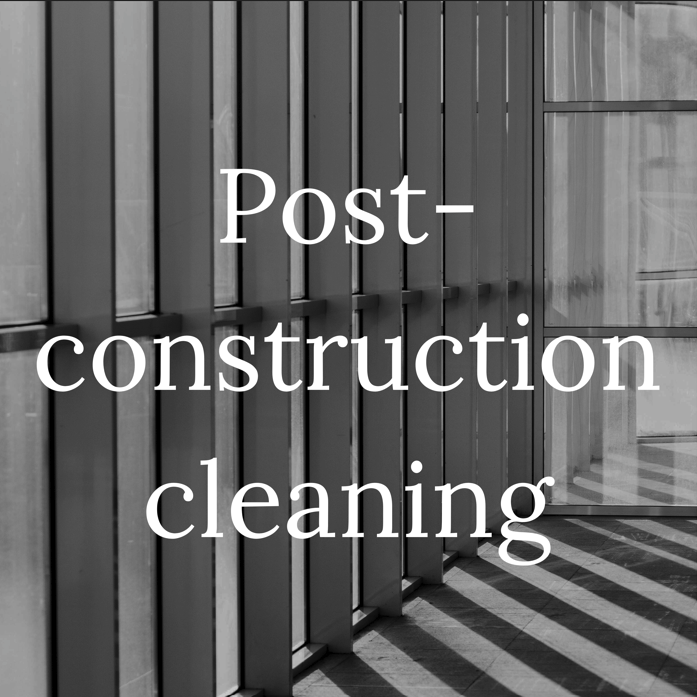 Sign with the text 'Post-construction cleaning' in white over a modern building interior with striped pattern flooring.