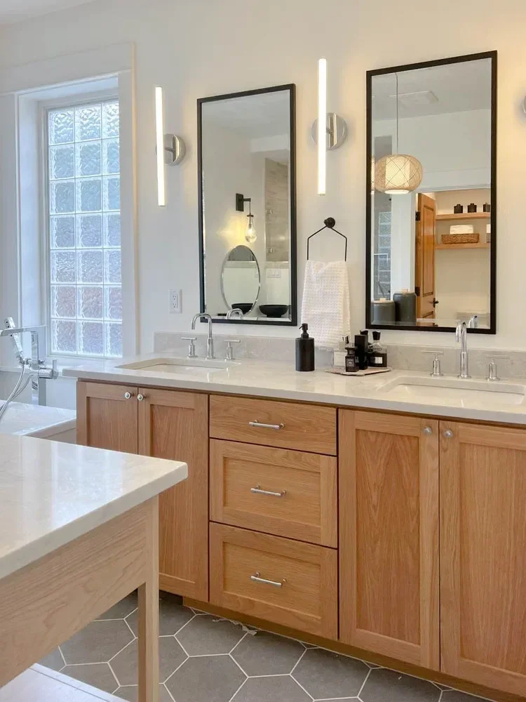 Modern home renovation featuring warm wood cabinetry, hex tile flooring, textured shower walls, and neutral-toned interiors in Southern Oregon, completed by Verity Construction.