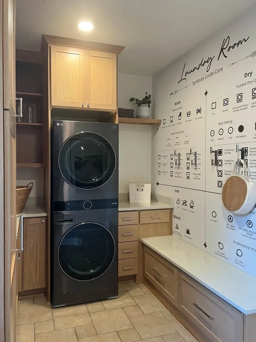 Modern home renovation featuring warm wood cabinetry, hex tile flooring, textured shower walls, and neutral-toned interiors in Southern Oregon, completed by Verity Construction.
