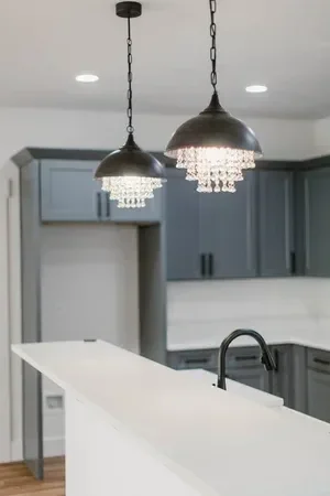Custom warm modern home with wood textures, matte black fixtures, and transitional-style finishes throughout — built by Verity Construction.