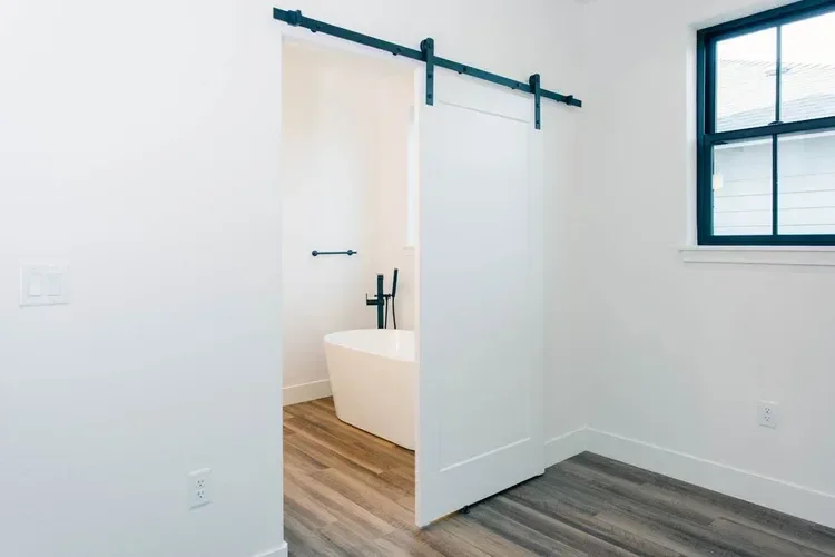 Custom warm modern home with wood textures, matte black fixtures, and transitional-style finishes throughout — built by Verity Construction.