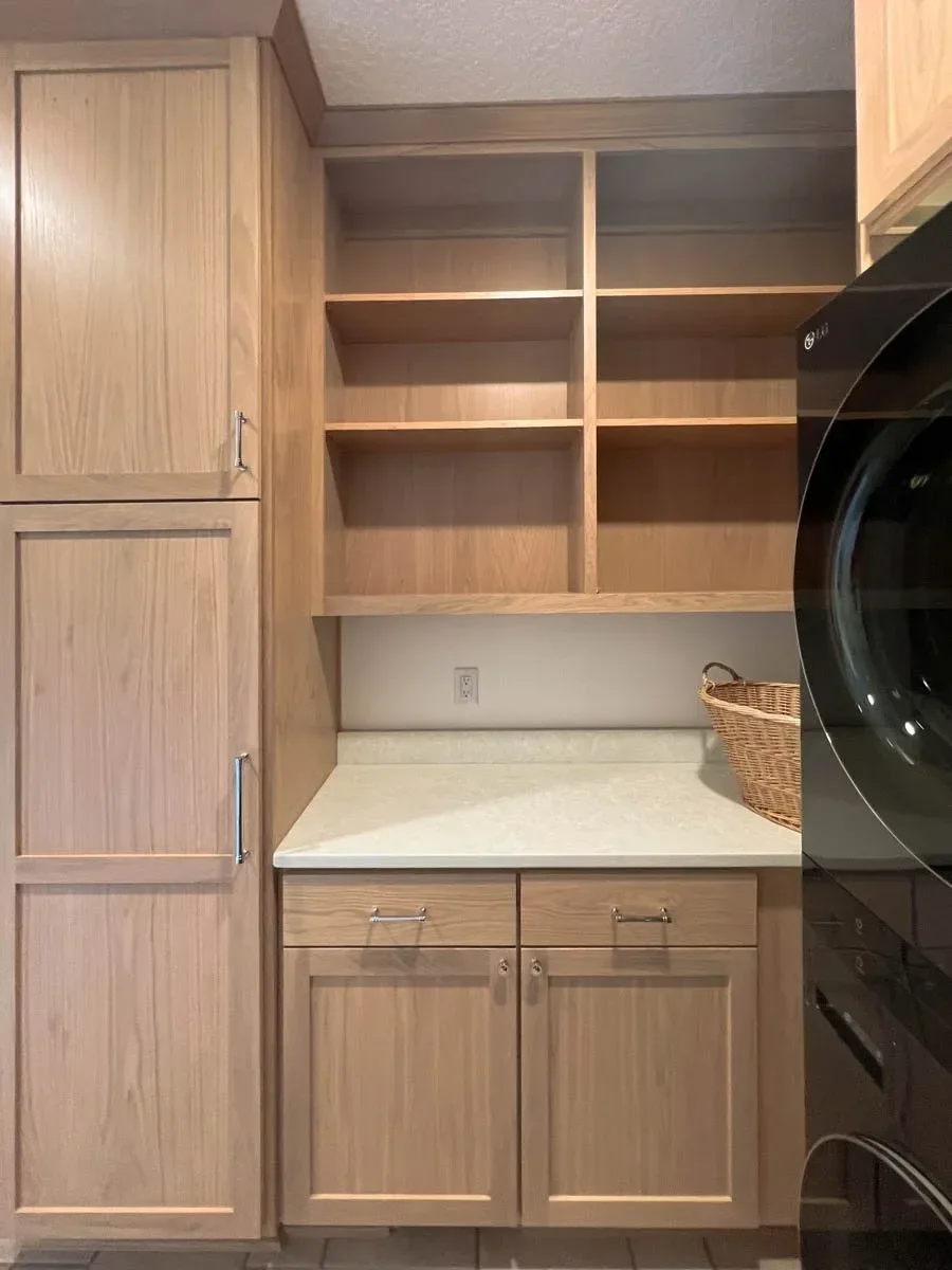 Modern home renovation featuring warm wood cabinetry, hex tile flooring, textured shower walls, and neutral-toned interiors in Southern Oregon, completed by Verity Construction.