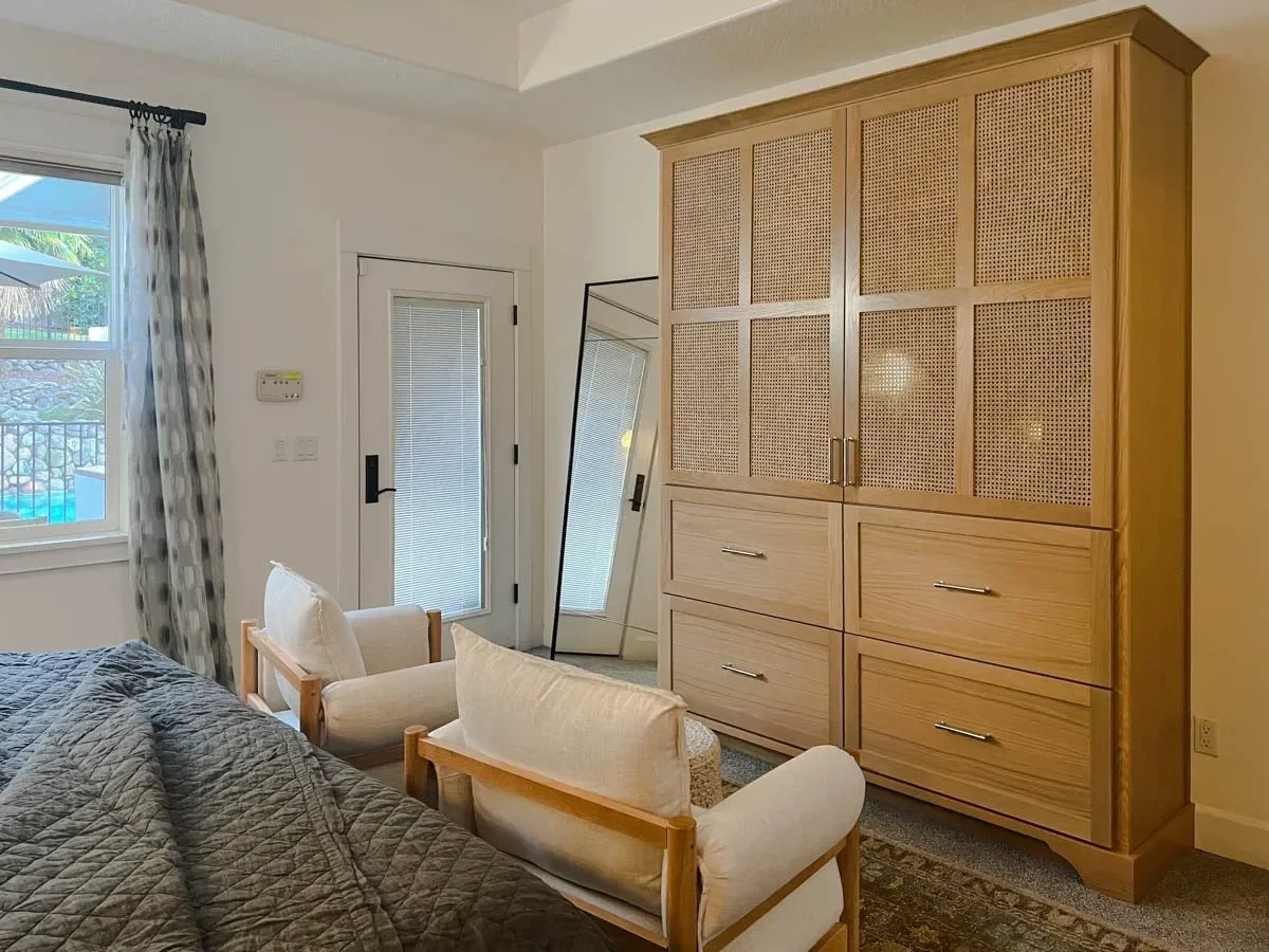 Modern home renovation featuring warm wood cabinetry, hex tile flooring, textured shower walls, and neutral-toned interiors in Southern Oregon, completed by Verity Construction.