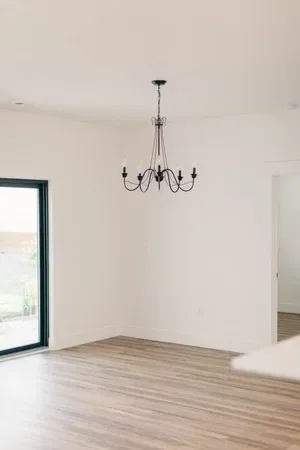 Custom warm modern home with wood textures, matte black fixtures, and transitional-style finishes throughout — built by Verity Construction.
