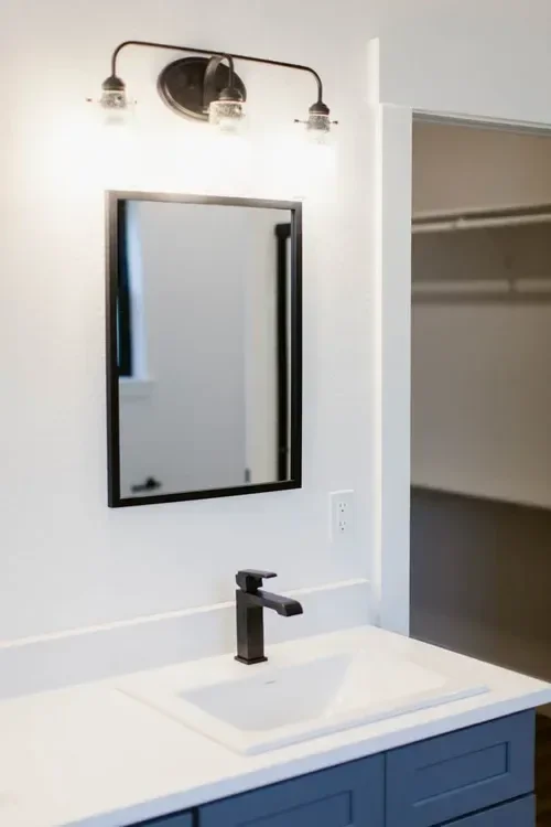 Custom warm modern home with wood textures, matte black fixtures, and transitional-style finishes throughout — built by Verity Construction.