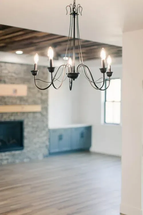 Custom warm modern home with wood textures, matte black fixtures, and transitional-style finishes throughout — built by Verity Construction.