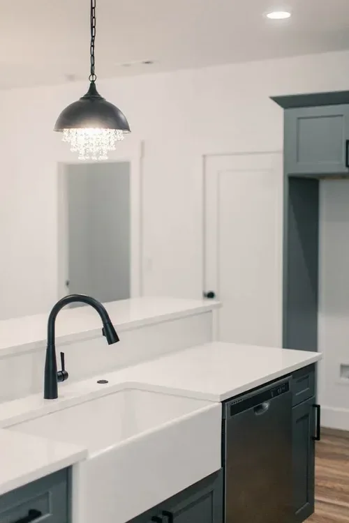 Custom warm modern home with wood textures, matte black fixtures, and transitional-style finishes throughout — built by Verity Construction.