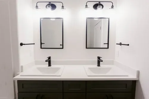 Custom warm modern home with wood textures, matte black fixtures, and transitional-style finishes throughout — built by Verity Construction.