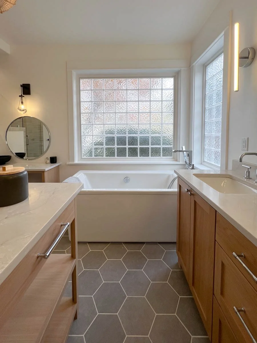 Bathroom remodel with soaking tub, dual vanities, and hex tile — completed by Verity Construction in Southern Oregon.
