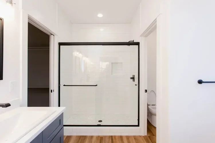 Custom warm modern home with wood textures, matte black fixtures, and transitional-style finishes throughout — built by Verity Construction.
