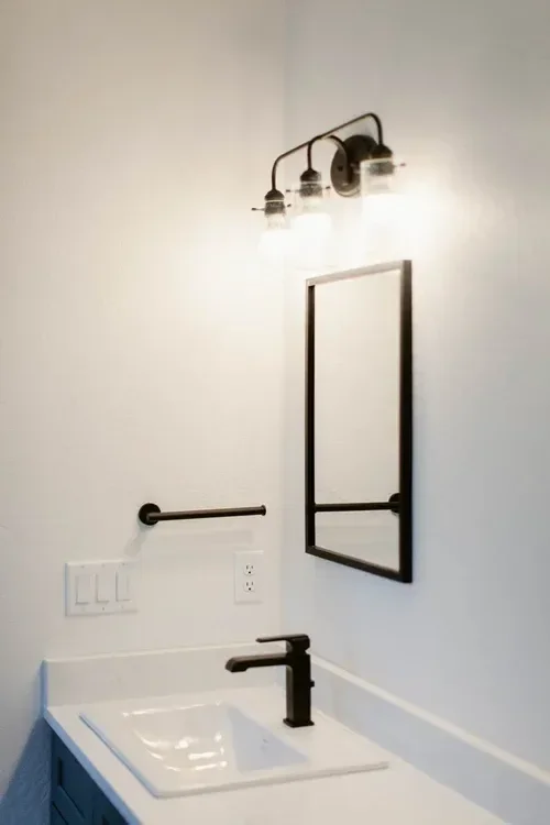 Custom warm modern home with wood textures, matte black fixtures, and transitional-style finishes throughout — built by Verity Construction.