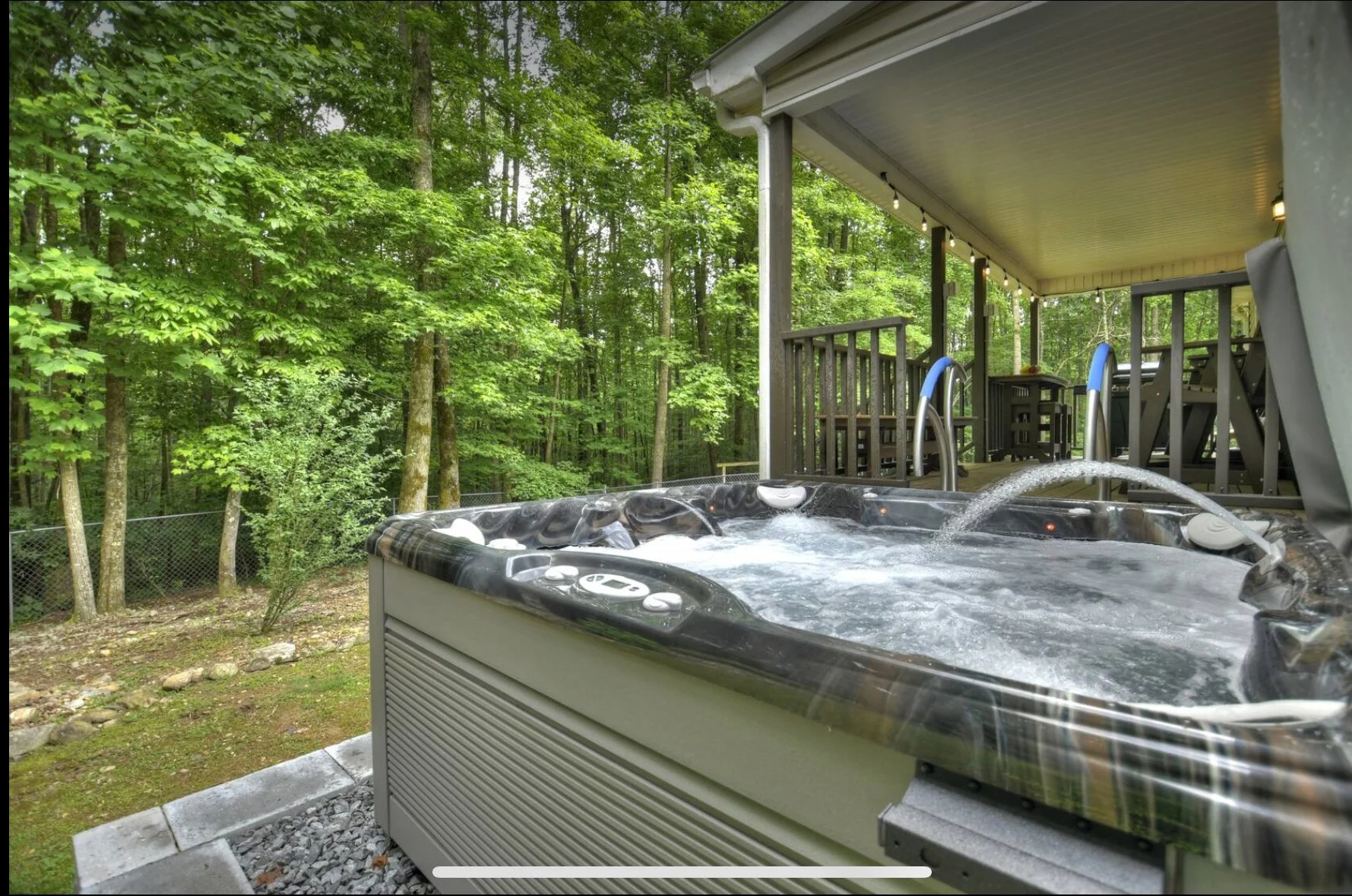 pacious 7-person hot tub on the covered deck, offering the perfect place to relax and unwind while enjoying the serene forest surroundings.