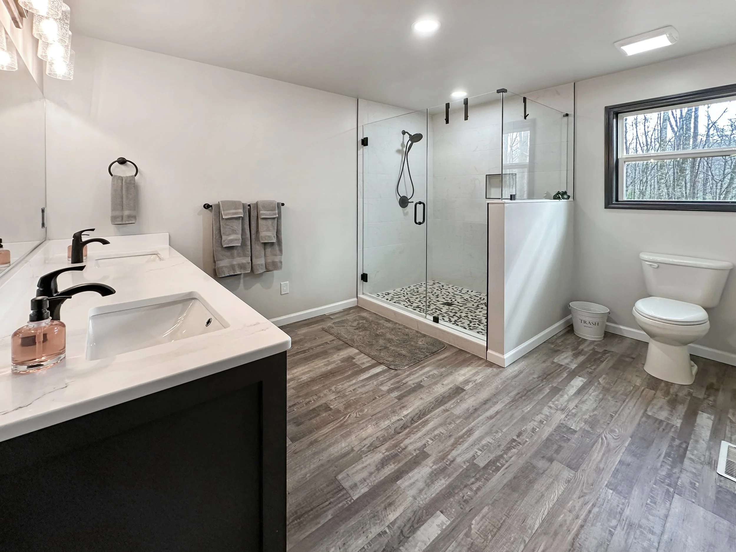 Spacious master bathroom with a double vanity, large walk-in shower, and modern fixtures. Featuring elegant finishes and ample lighting, this spa-like retreat offers both comfort and luxury.