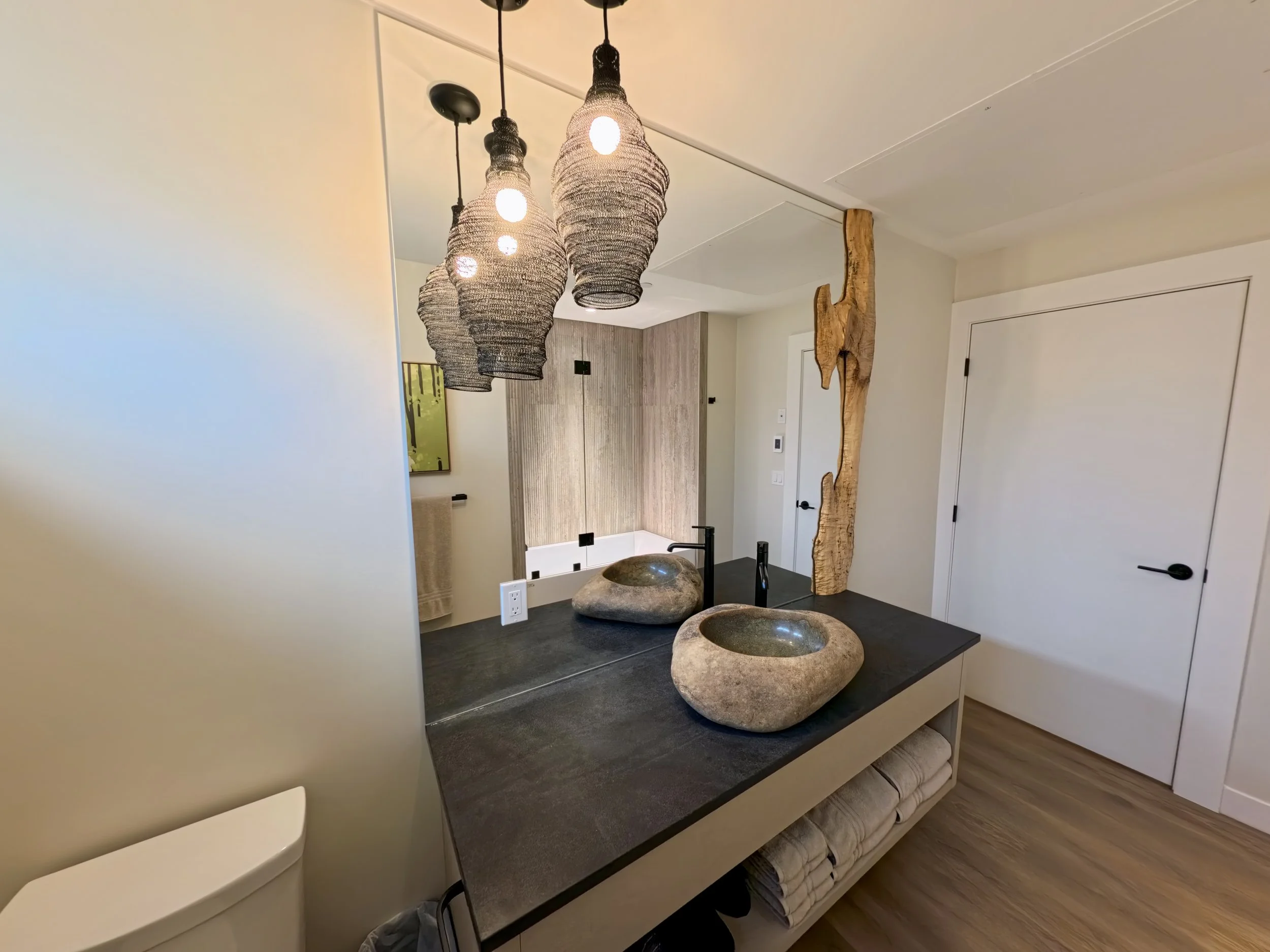 Custom cut mirror for back splash of vanity sink. Reflection of shower glass work in the mirror 