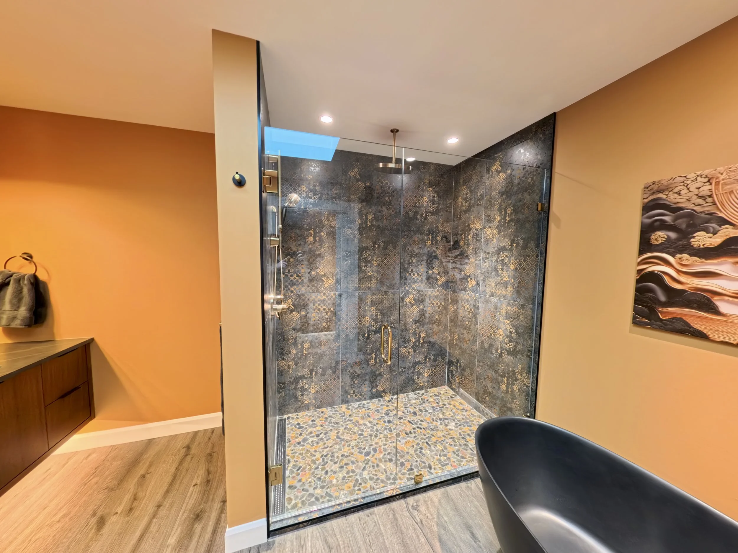 Full glass shower door with half swing door with gold hardware
