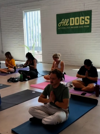 Friends enjoying yoga with their pups at a past All Dogs Event