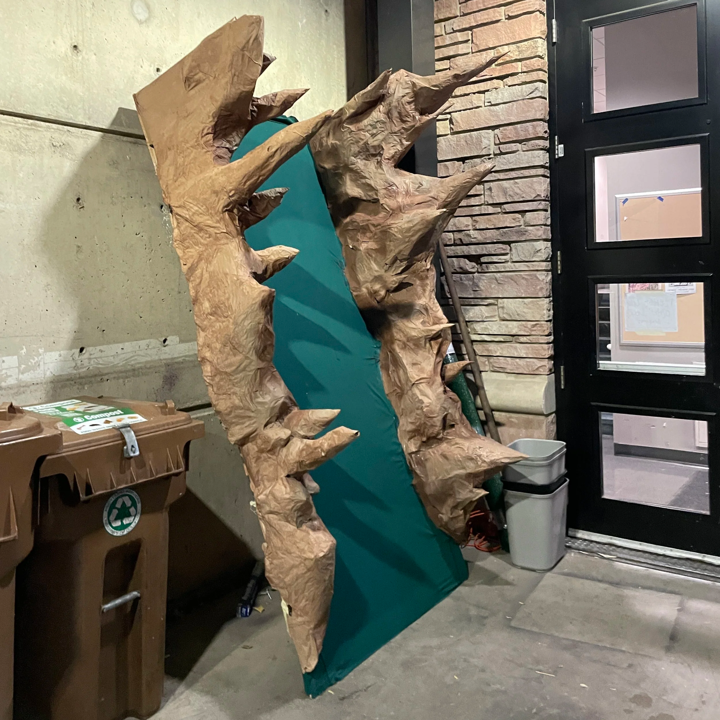 a platform with spikes leaning against a wall