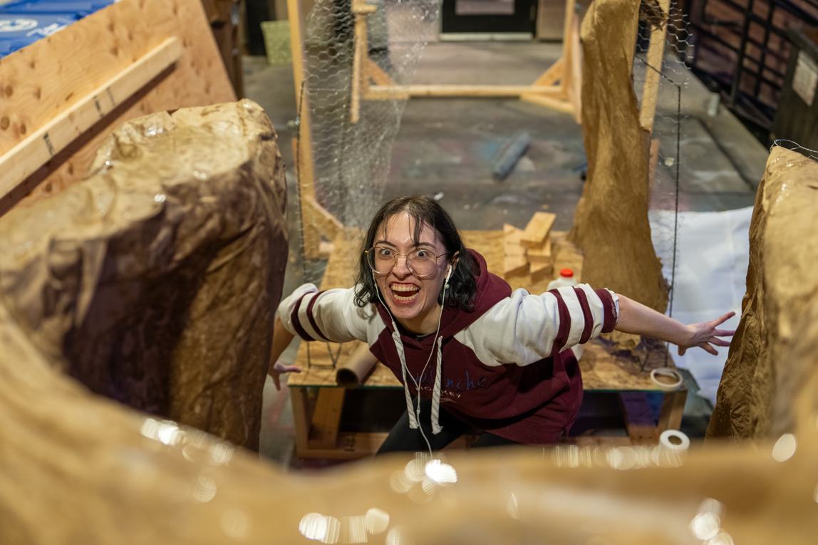 A girl crouching while looking at the camera