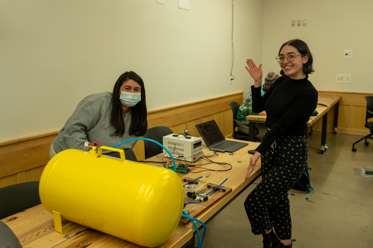 Two girls posing with electronic equipment