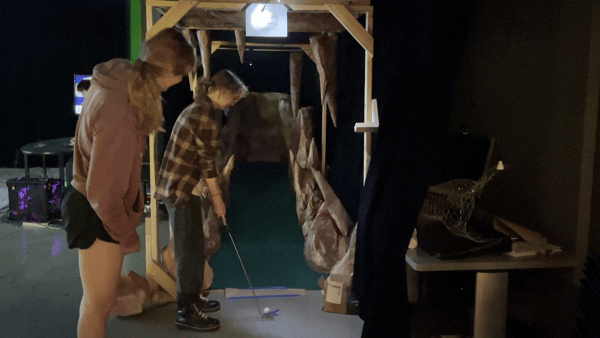 people playing minigolf