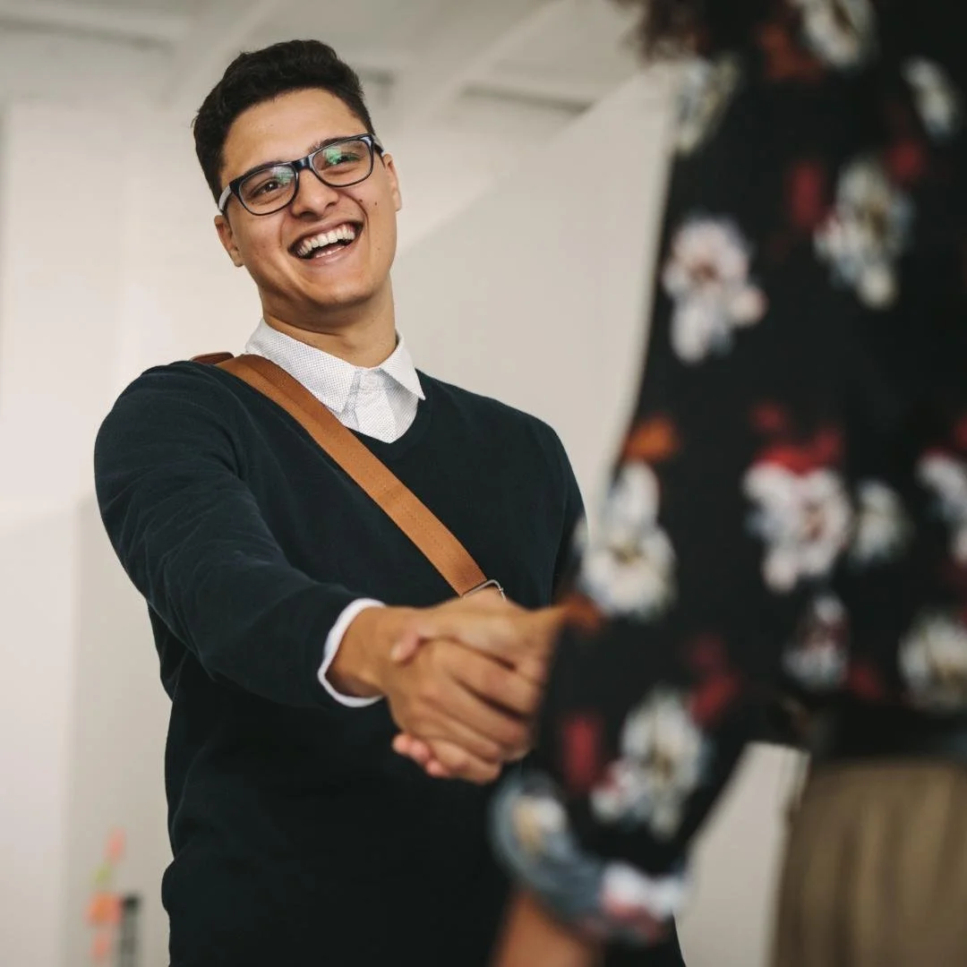 Smiling appraiser wearing glasses shaking hands with client