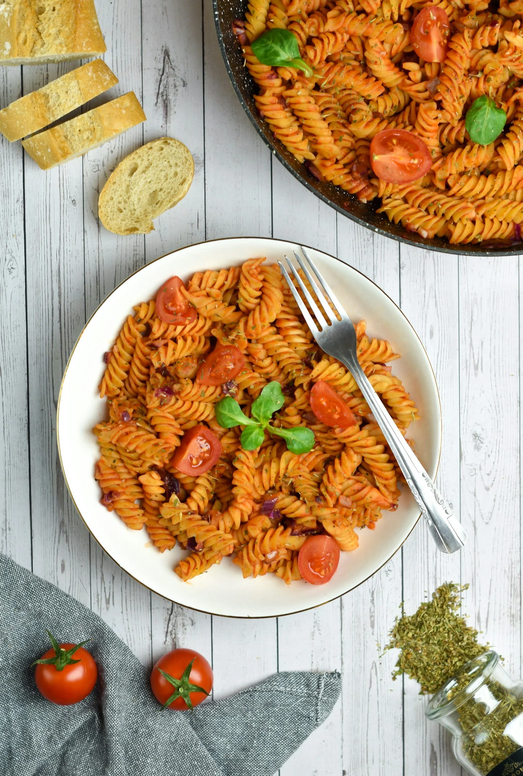 Plate of pasta with bread on the side.