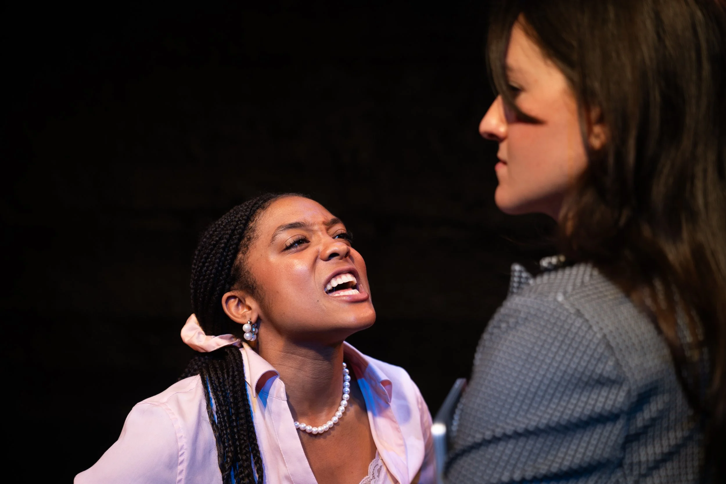 Remidy Destyn Dixon in "In Chief" - Two women engaged in an intense argument, one woman appears angry and is yelling, while the other looks stern and confrontational.