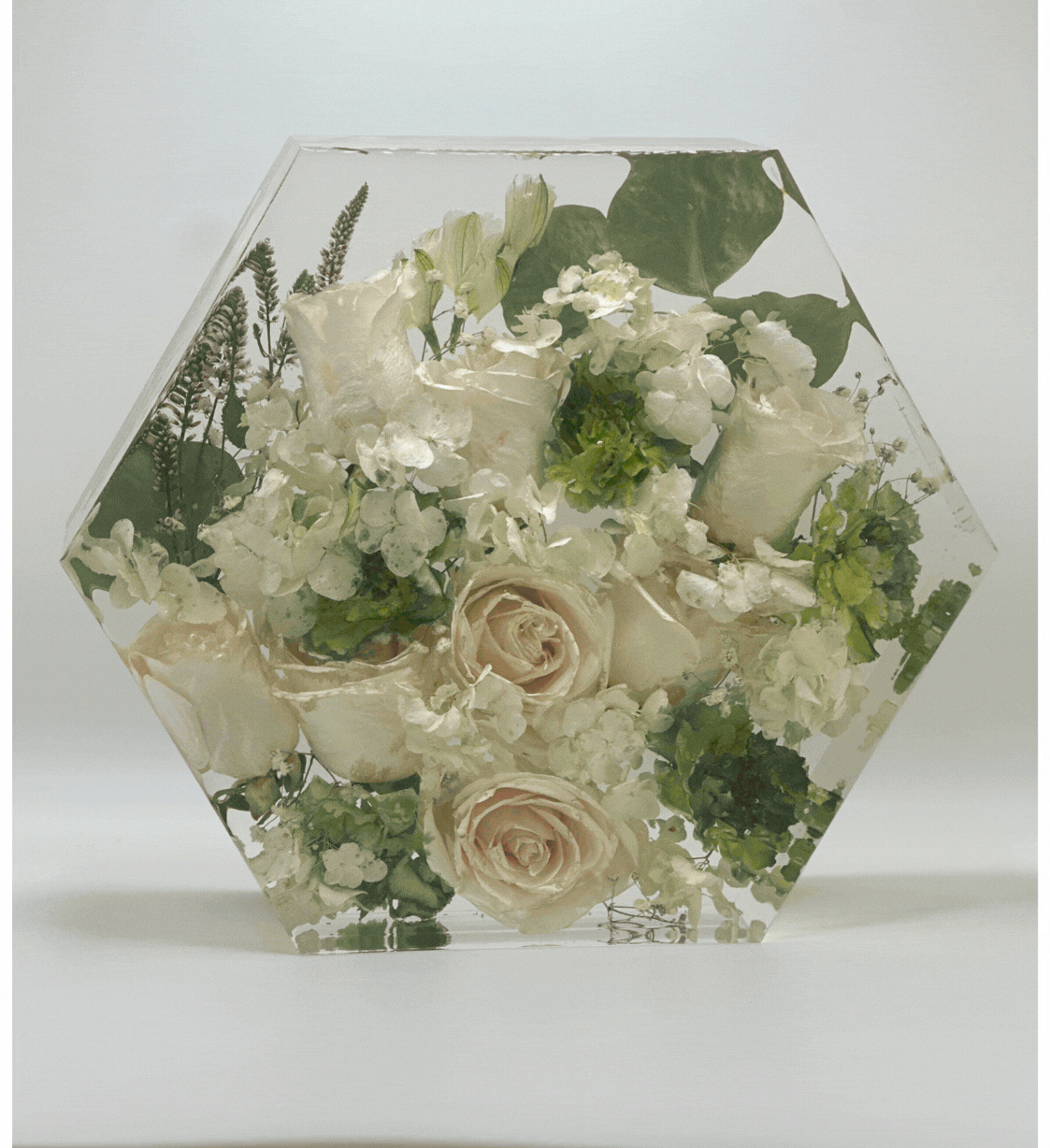 A hexagonal floral preservation resin piece.