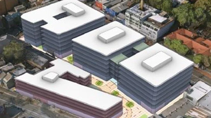 Architectural model of four modern buildings arranged to form the word "HELLO" from an aerial view, surrounded by trees and streets.