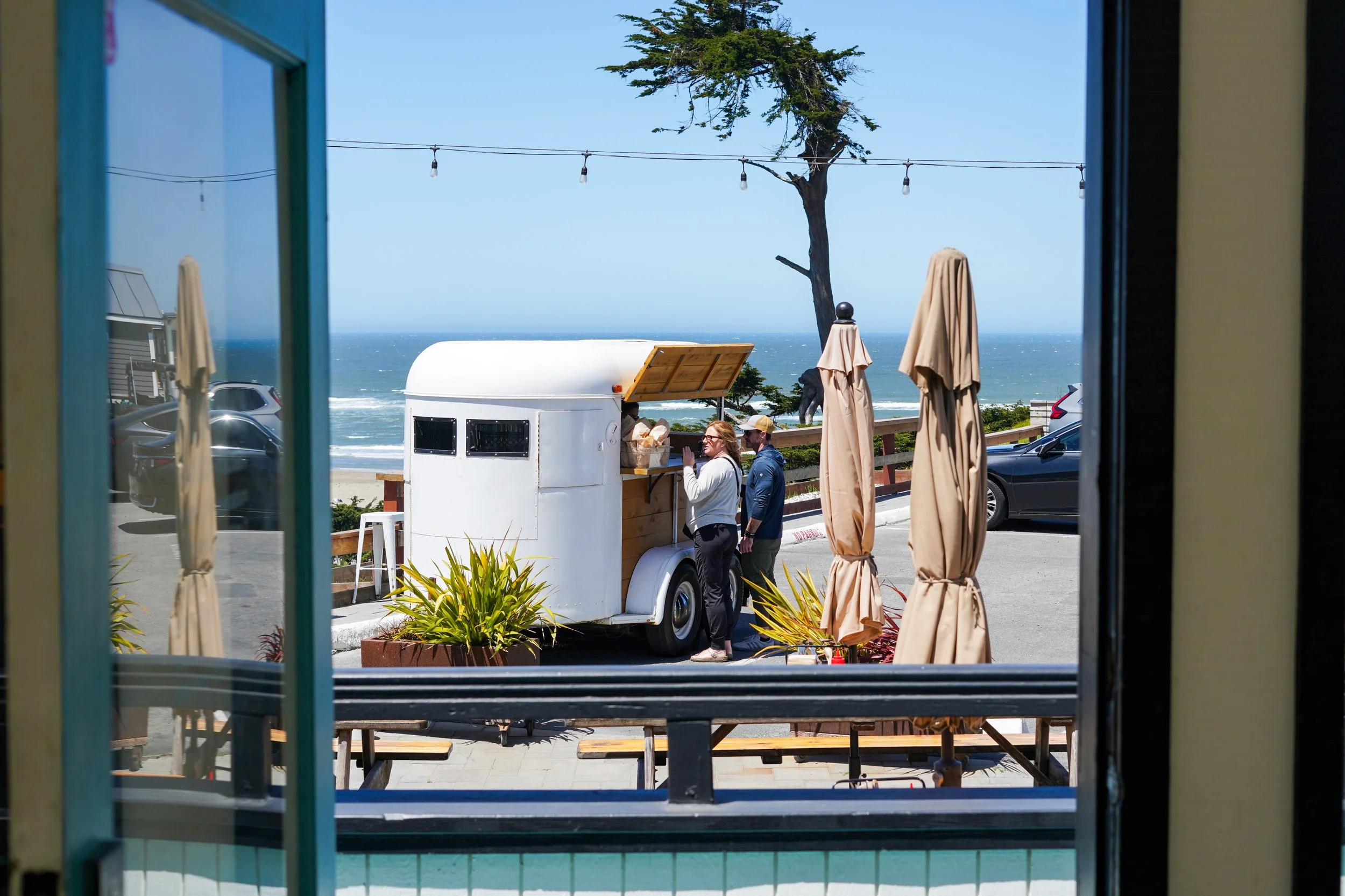 people ordering at the bar cart at the Coastal Kitchen located onsite at Dillon Beach Resort