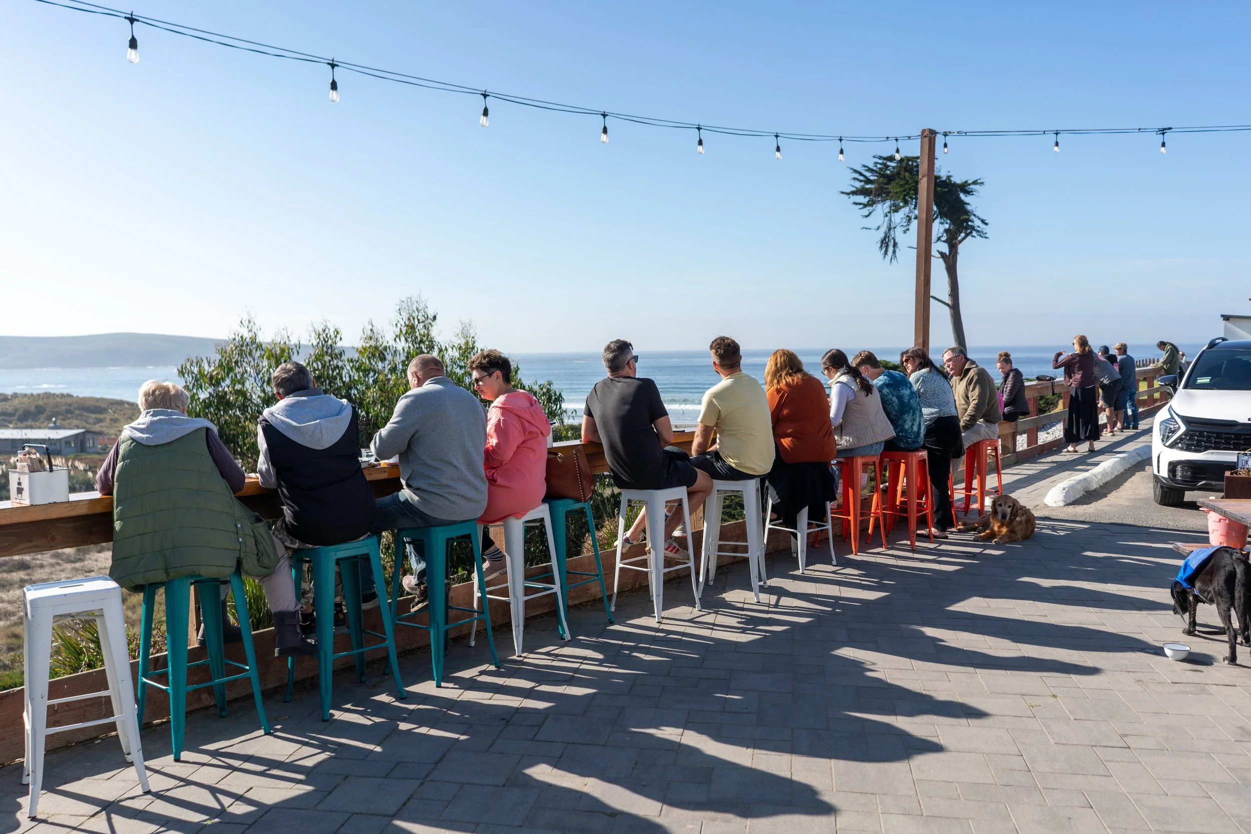 People enjoying the view of Dillon Beach at the Coastal Kitchen located onsite at Dillon Beach Resort