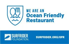 Logo of an ocean-friendly restaurant with a shield emblem, fork and knife, and text promoting ocean-friendly dining, along with the Surfrider Foundation logo and website.