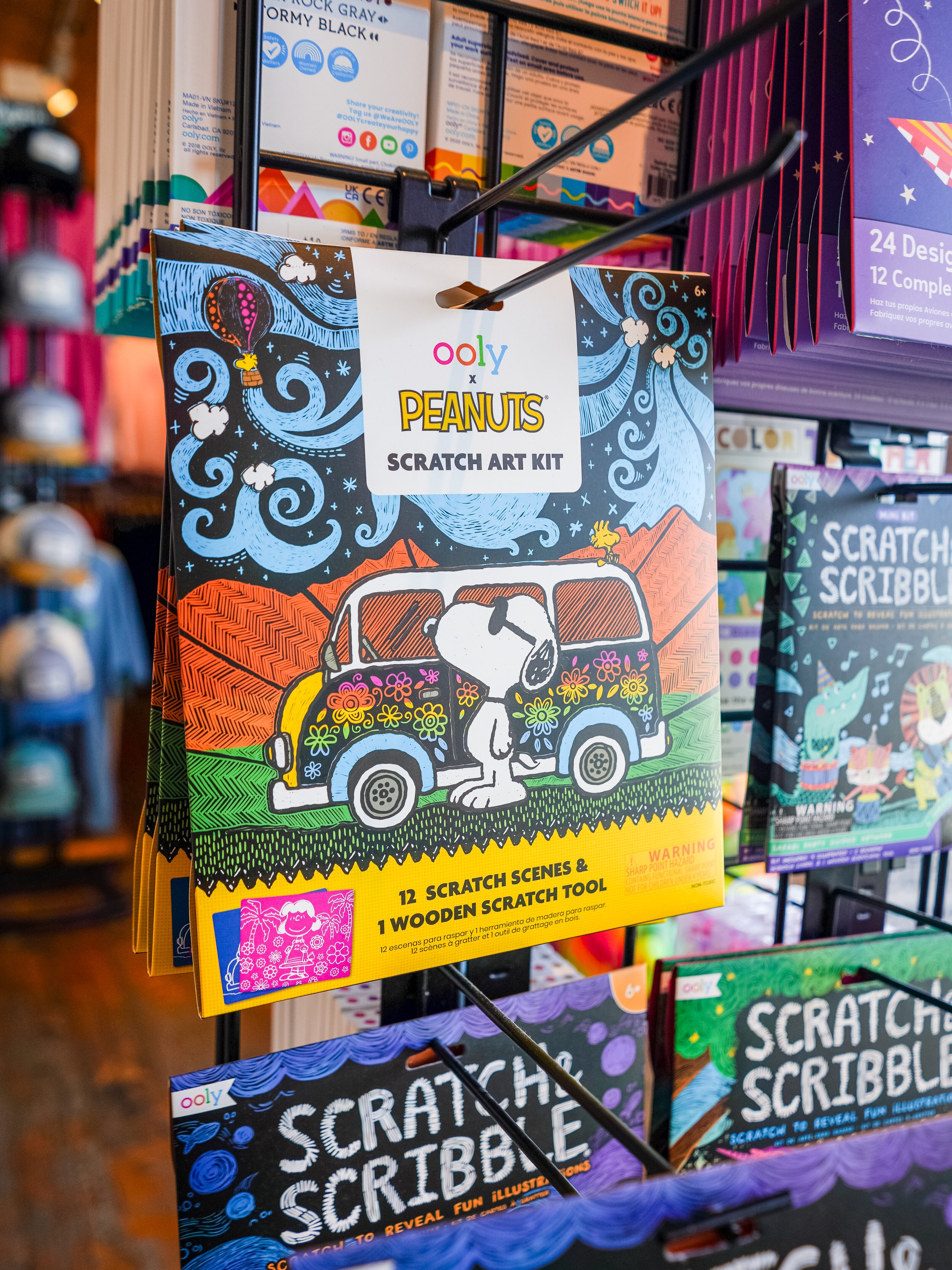 Colorful Peanuts scratch art kit on display at a store.