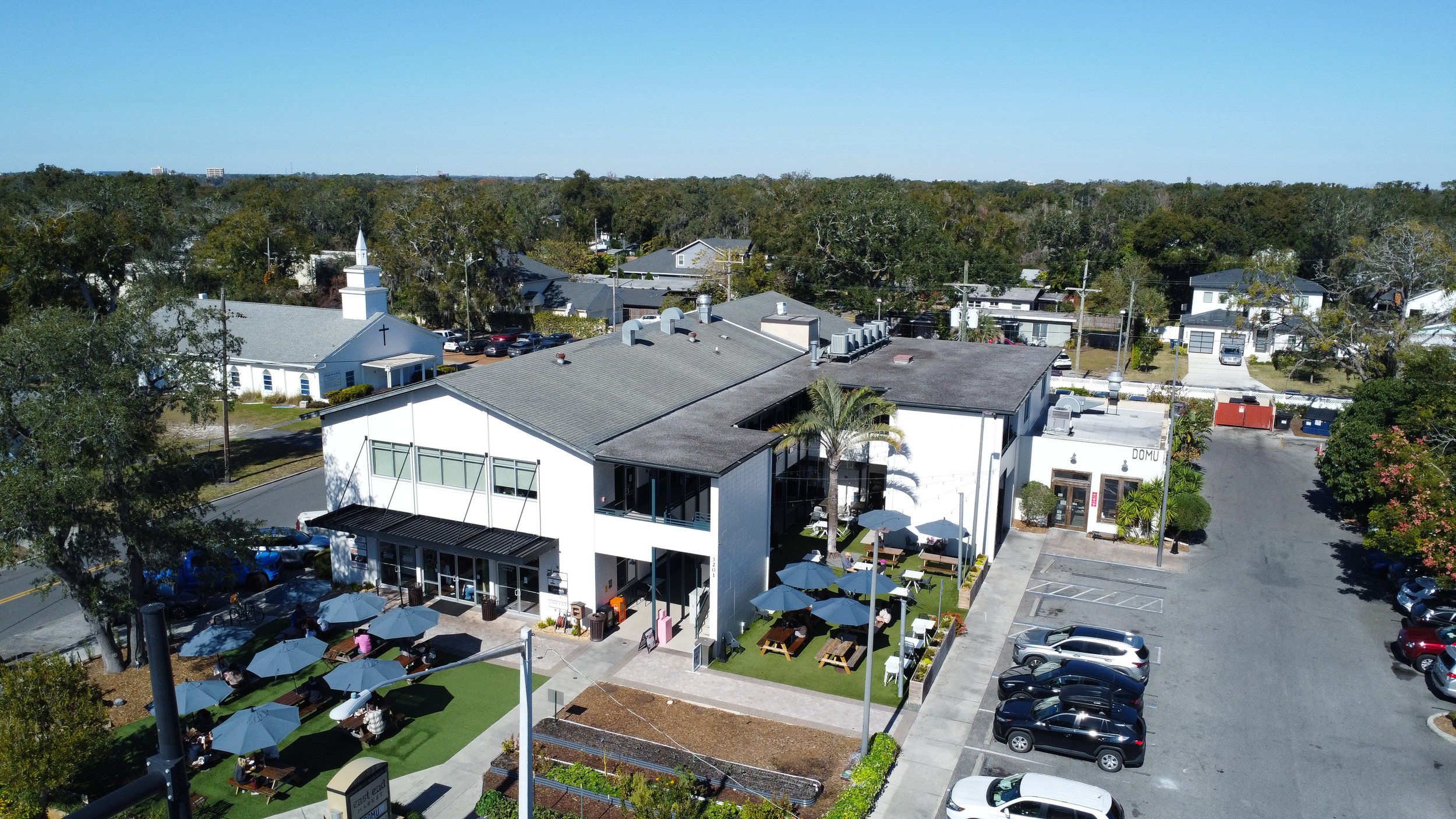 Commercial exterior painting in Winter Park FL — LG Master Painting revitalizes business property with outdoor seating for enhanced curb appeal.