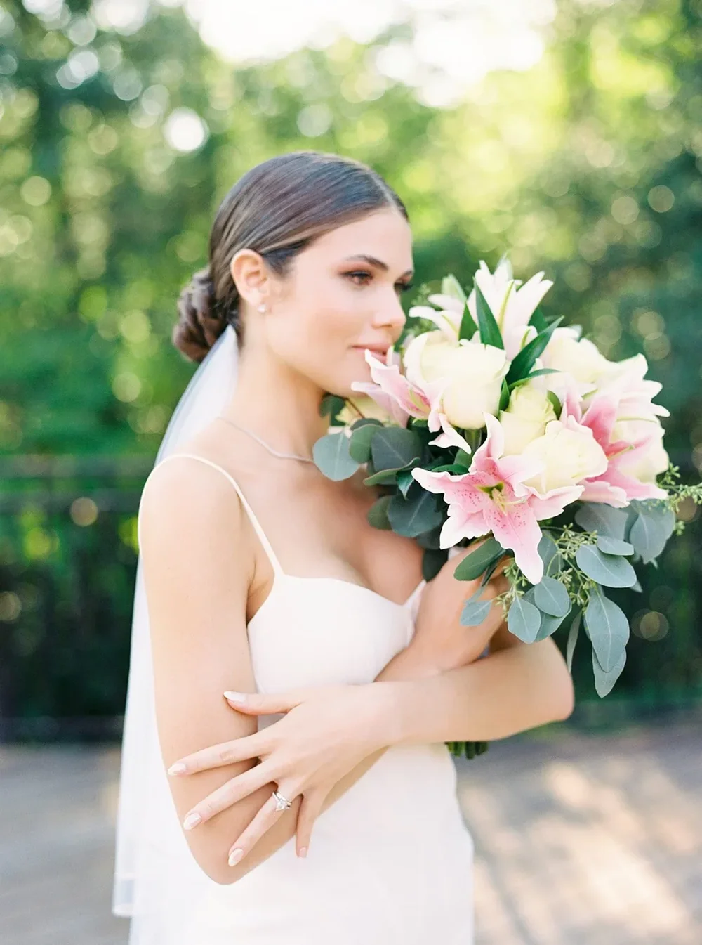 Modern bridal portrait in a sleek white gown, luminous editorial lighting and refined styling