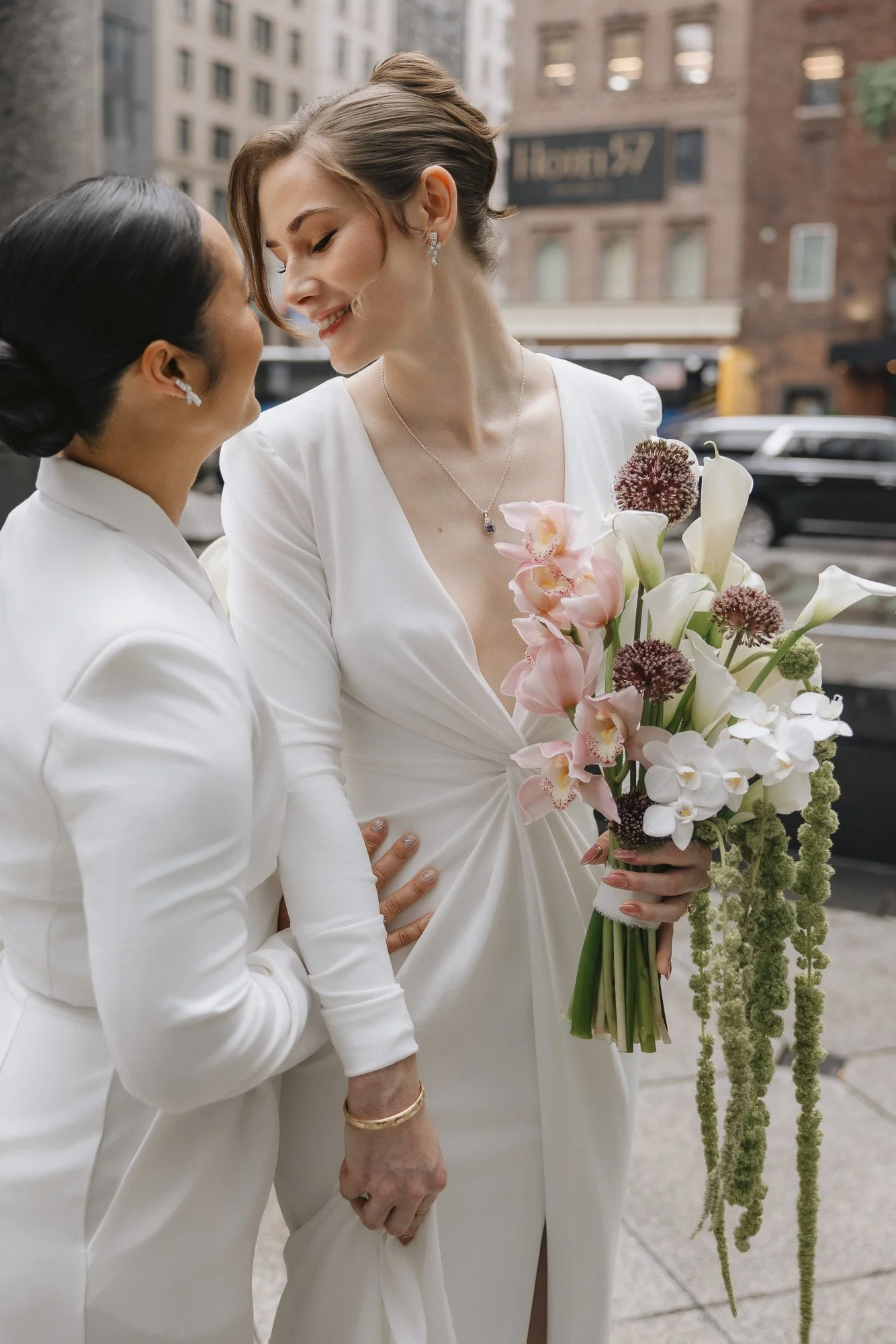 Stunning bridal bouquet with calla lily, hanging amaranth and cymbidium orchid in bride's hands
