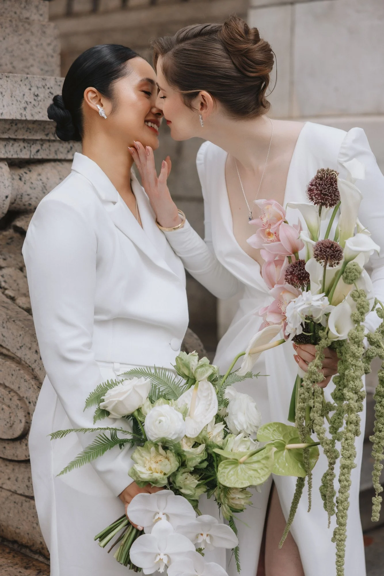 Modern and whimsy bridal bouquets held by LGBTQ couple
