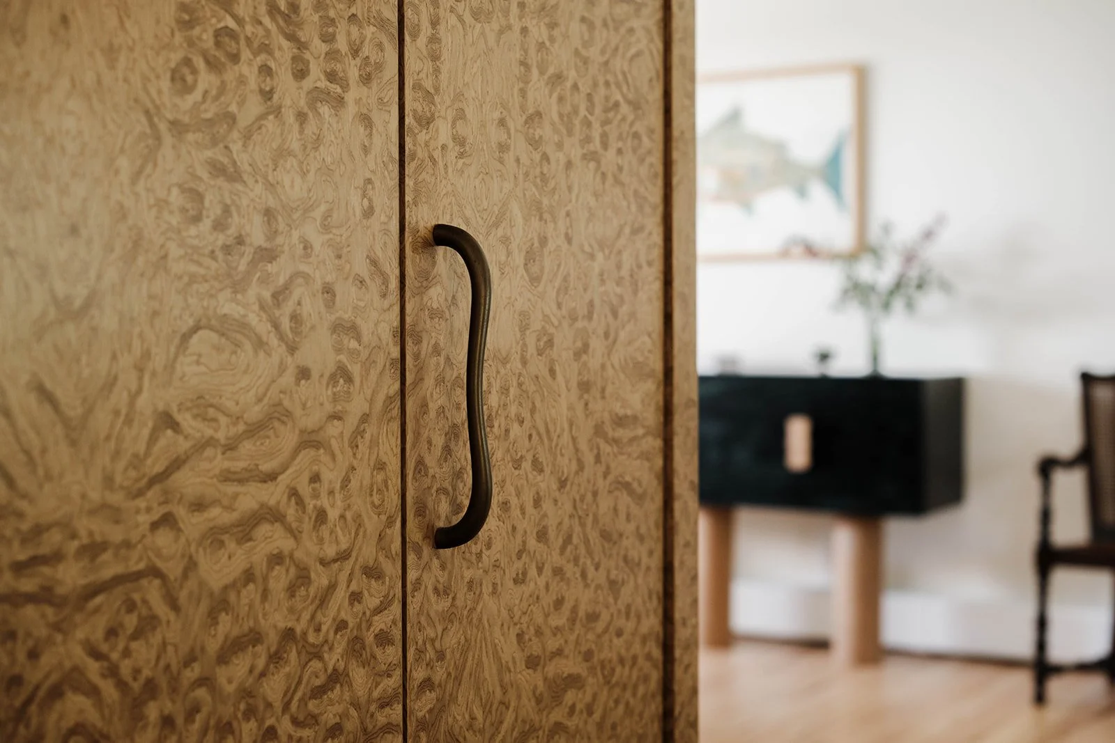 Burlwood and hardware detail of custom enclosed mini bar by Milieu Studio, interior designer in Jersey City