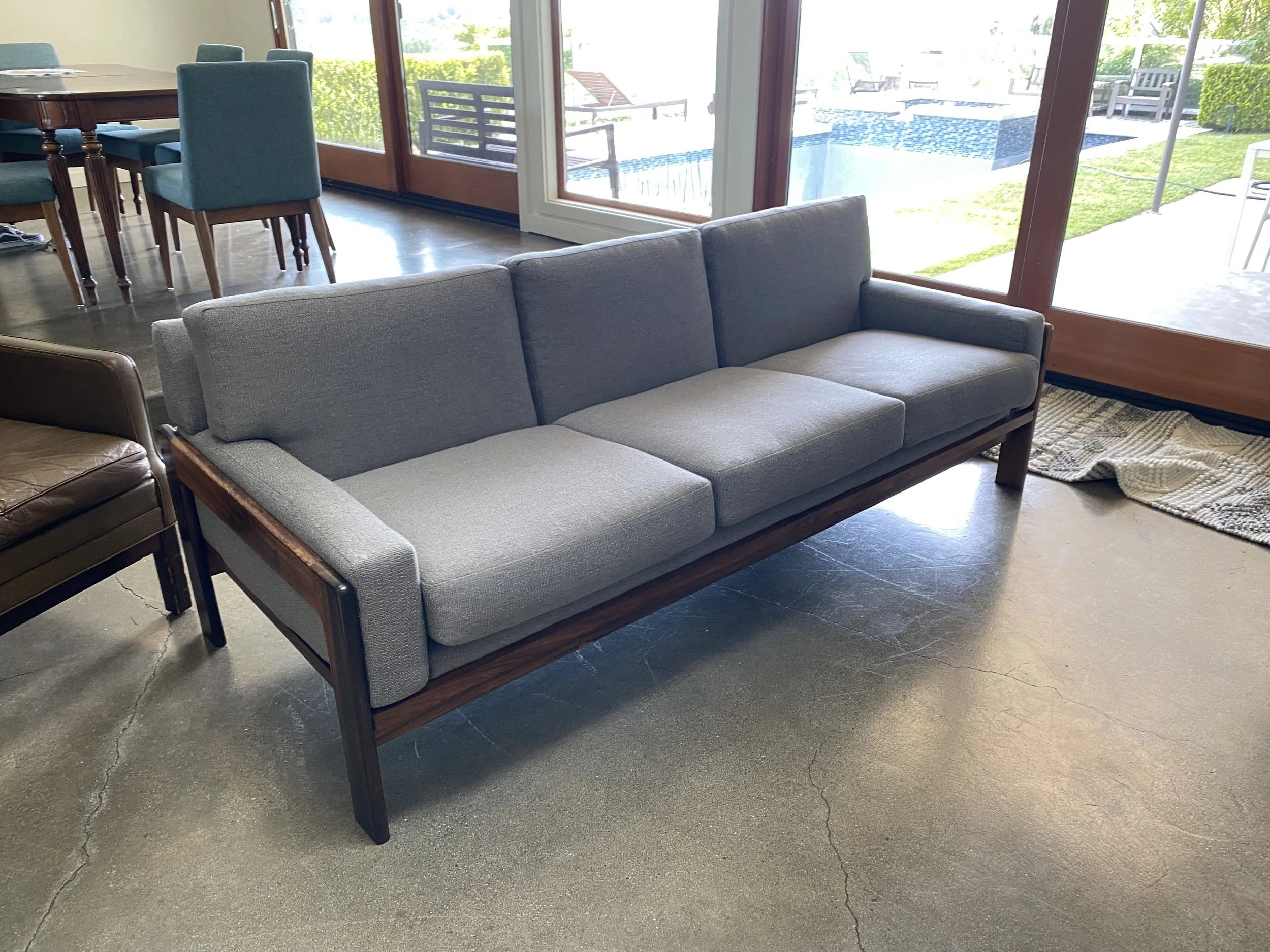 Reupholstered mid-century sofa with new foam cushions and refinished wood. 