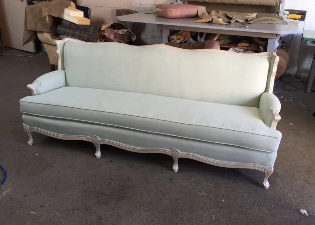 Antique style sofa loveseat upholstered in a light grey velvet fabric. 
