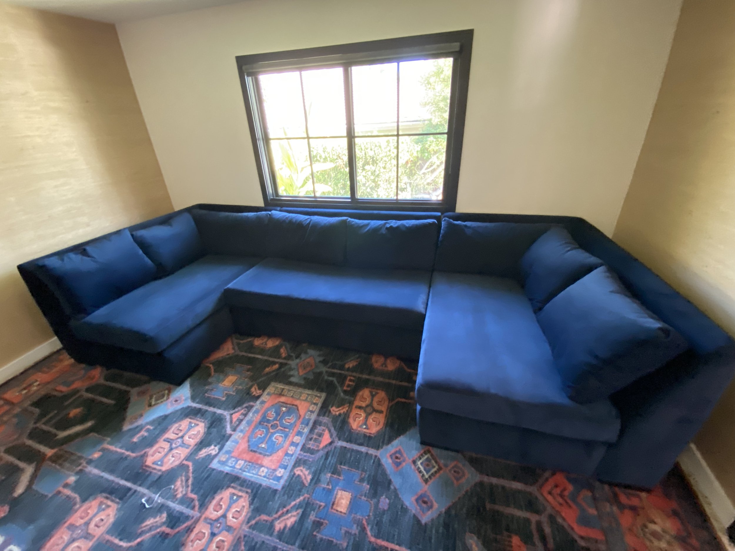 3 piece sectional which has had the frame modified and reupholstered in a blue denim/chenille. This sectional has down-and-feather cushions in the back and foam in the seats. 