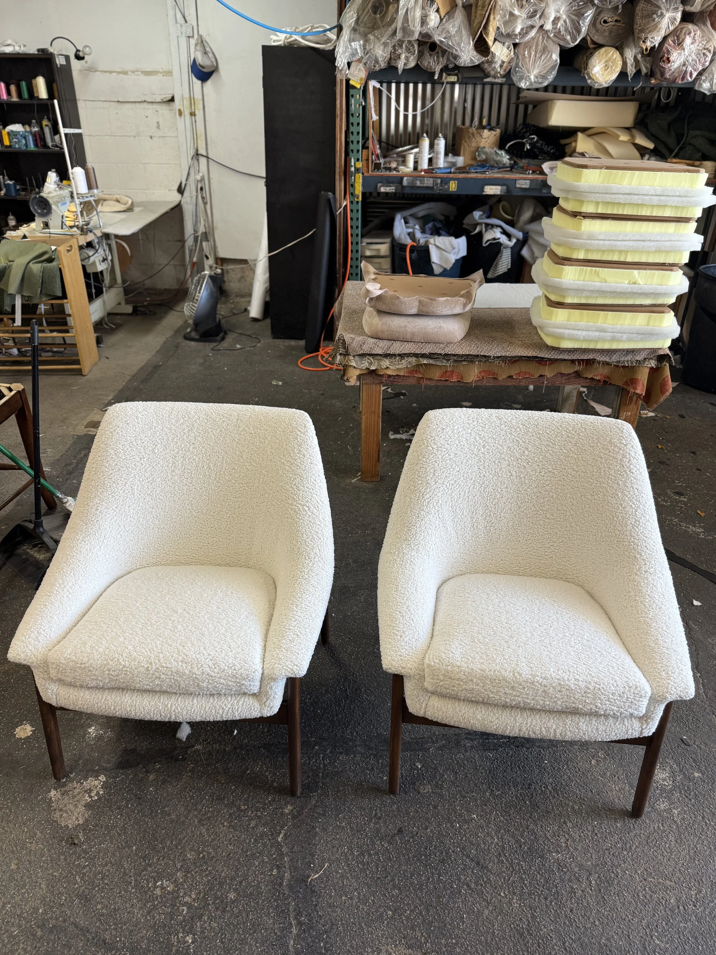 Mid-century chairs reupholstered in a white boucle performance fabric. 