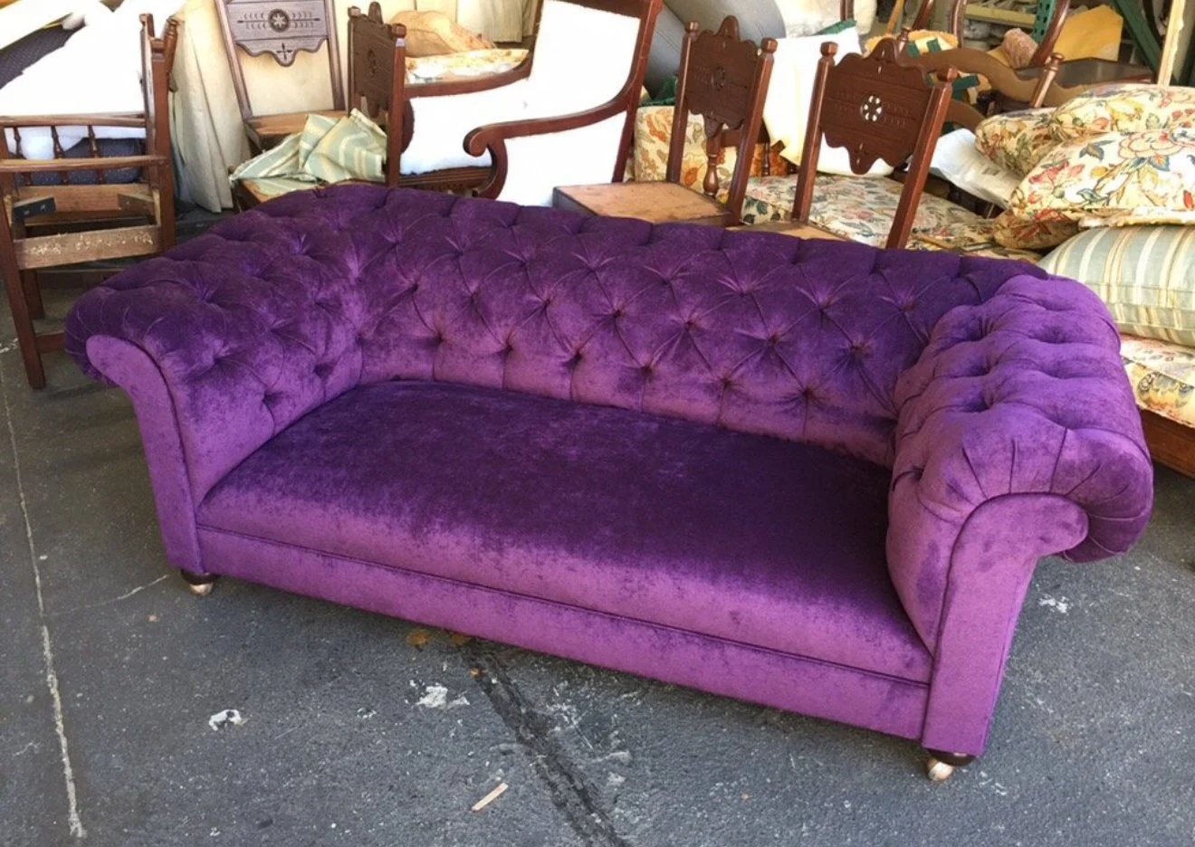 Antique tufted sofa reupholstered in a purple velvet.