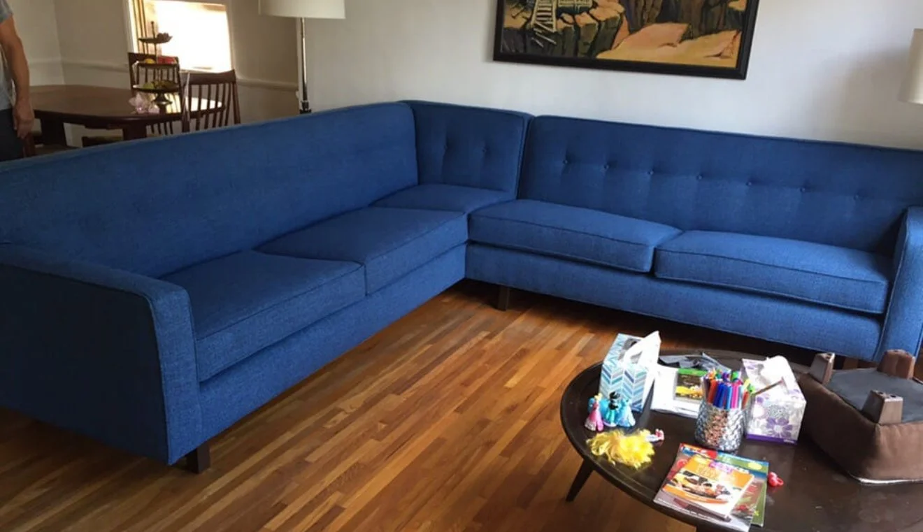 2-piece sectional reupholstered in a blue tweed performance fabric with square tufting and buttons. 