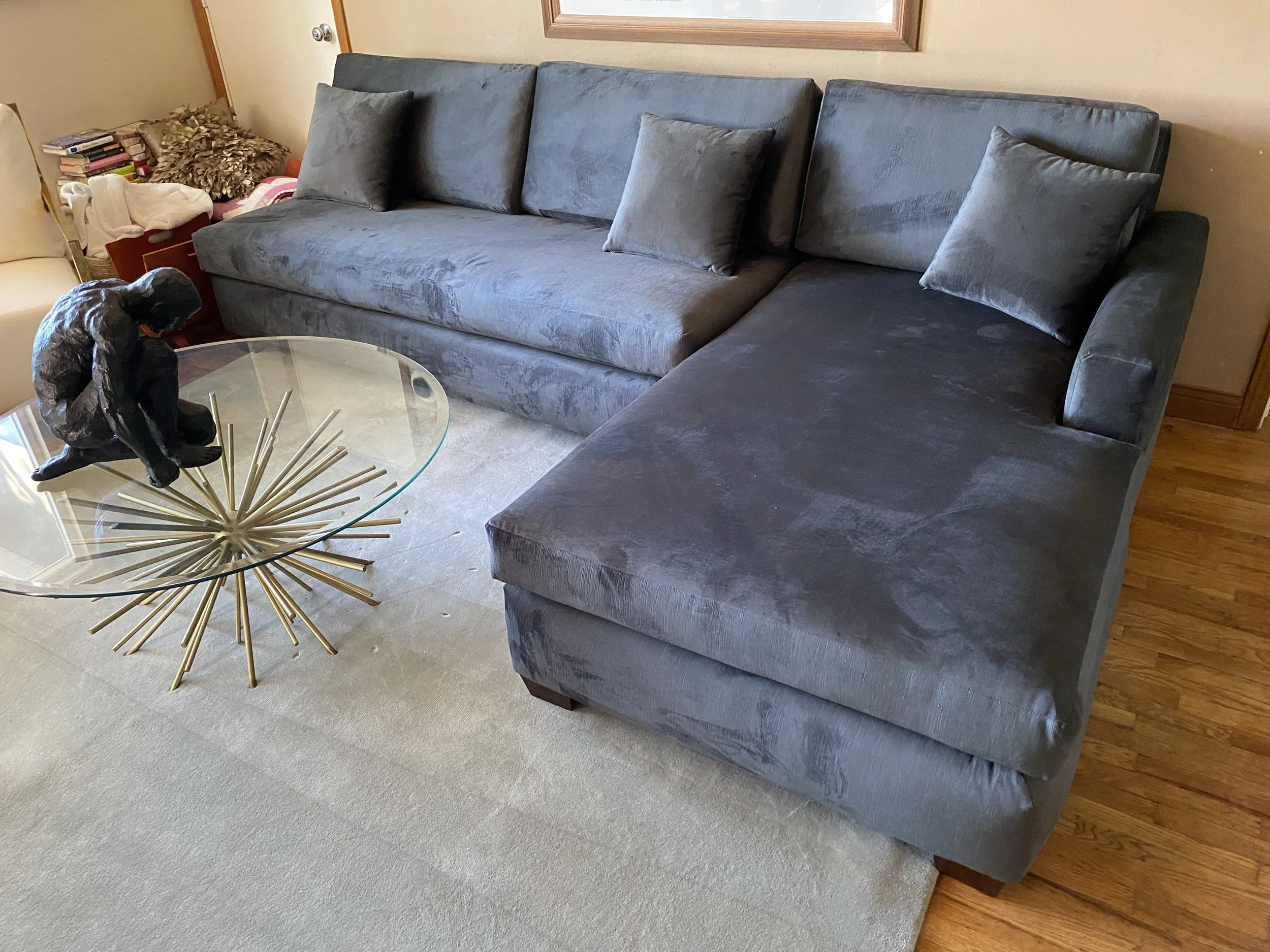 Sectional with chaise reupholstered in a luxurious grey chenille fabric using new foam and throw pillows. 