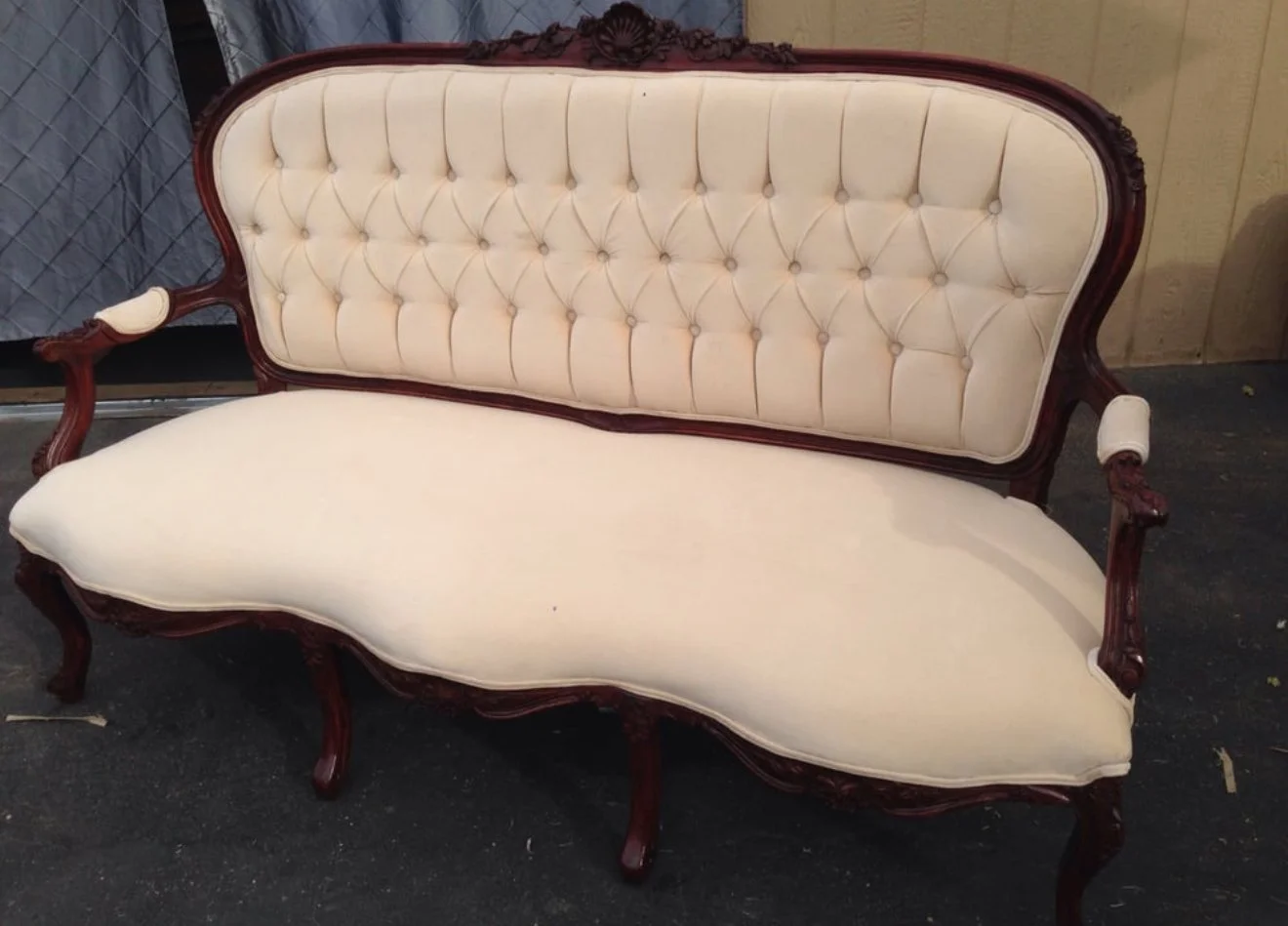 Antique tufted loveseat reupholstered in a white performance velvet fabric. 
